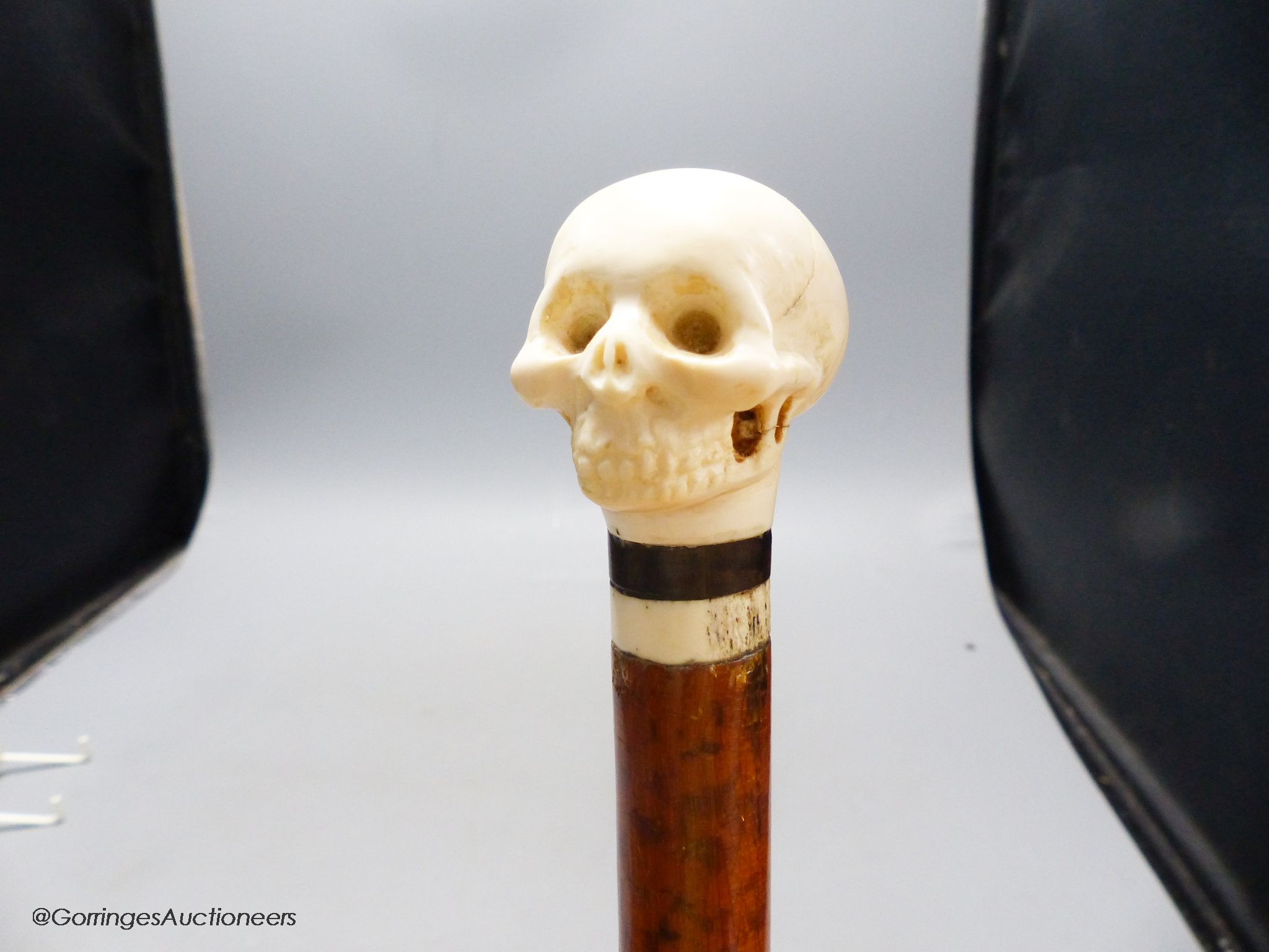 A malacca and ivory skull handled walking stick